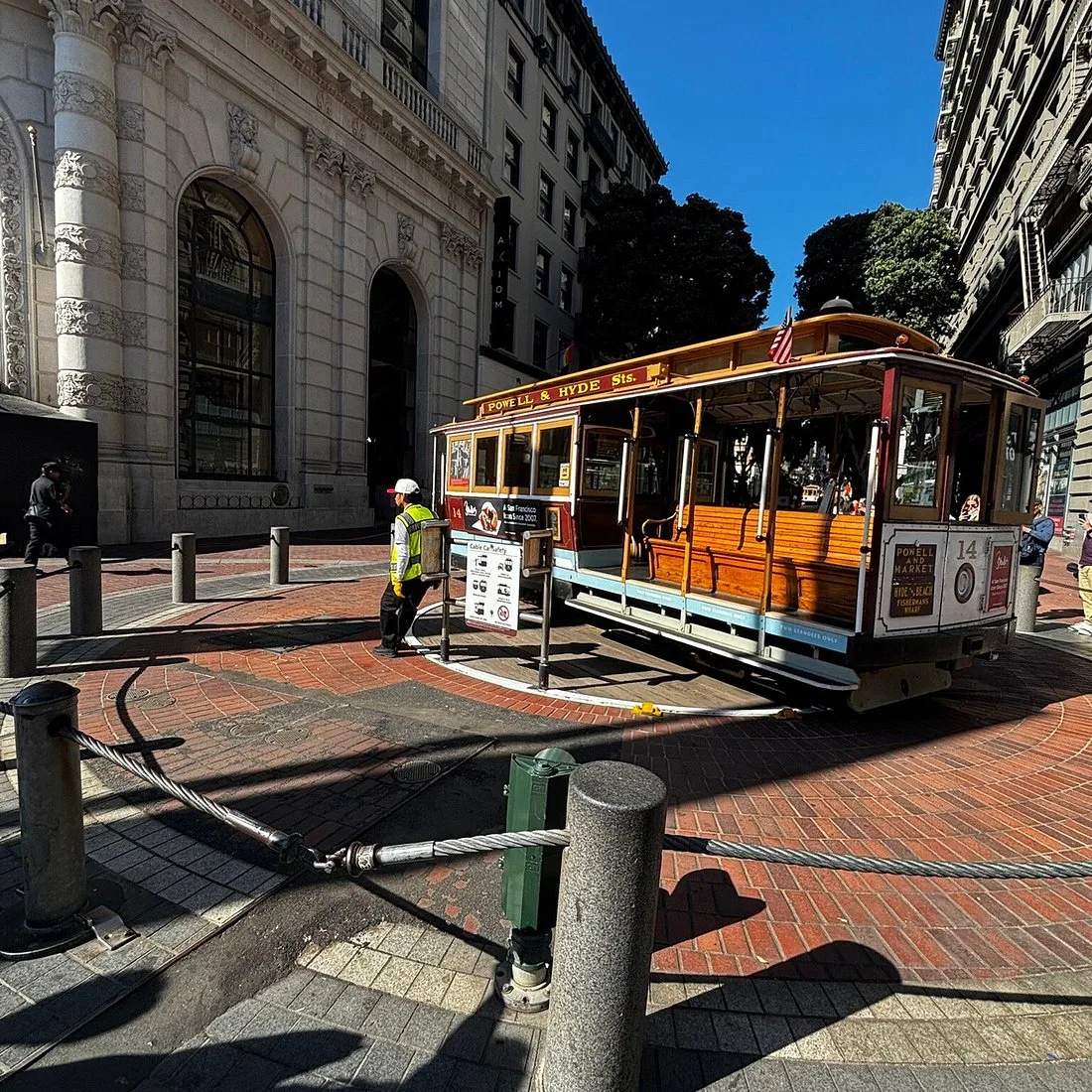 Powell Market Cable Car Turnaround with workers manually rotating the cable car